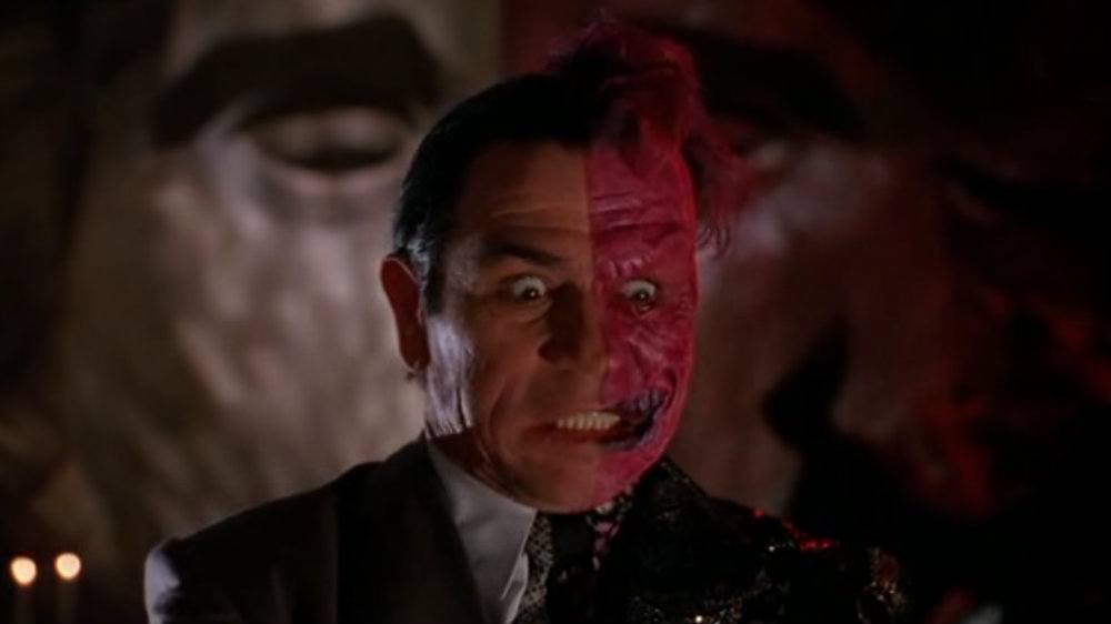 Tommy Lee Jones has half of his face painted red in Batman Forever
