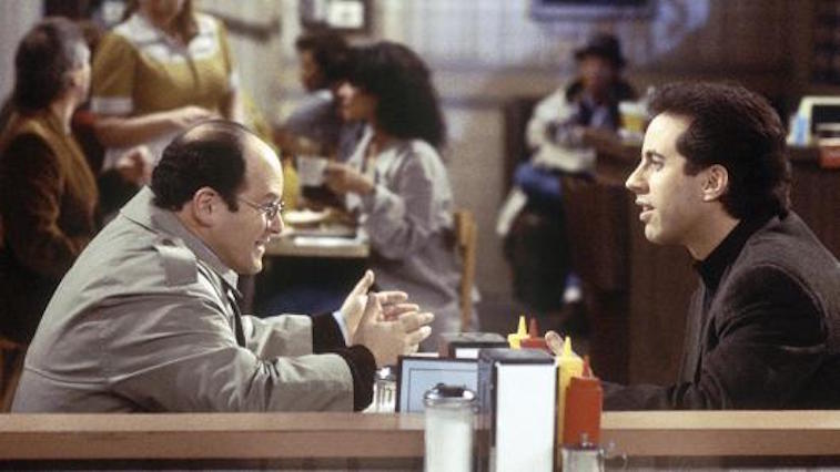 Jason Alexander as George Costanza and Jerry Seinfeld sitting in a booth in a diner on Seinfeld