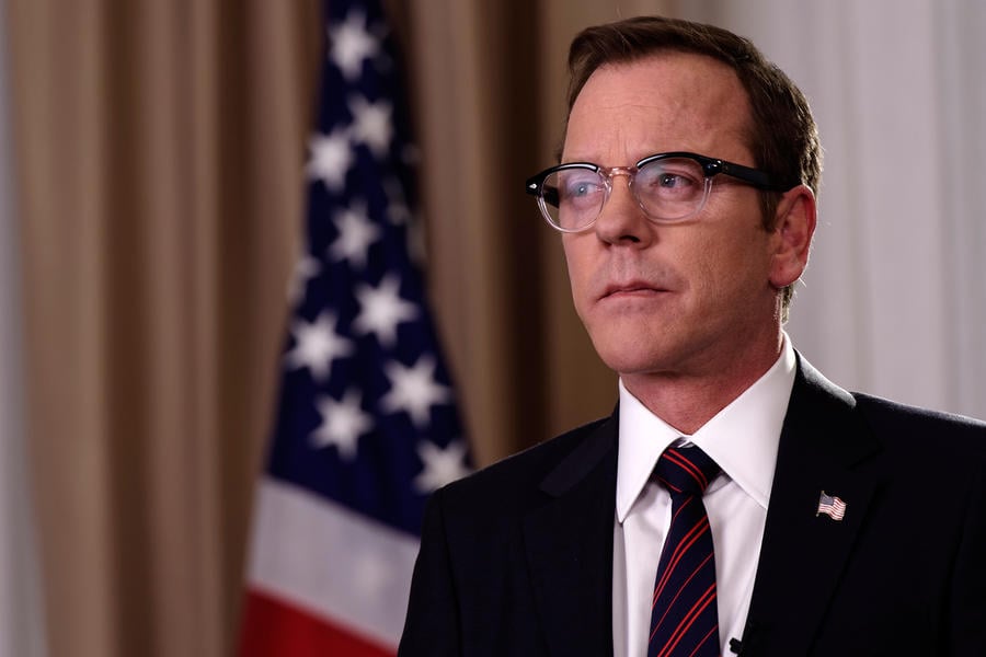 Kiefer Sutherland stands in front of an American flag in Designated Survivor