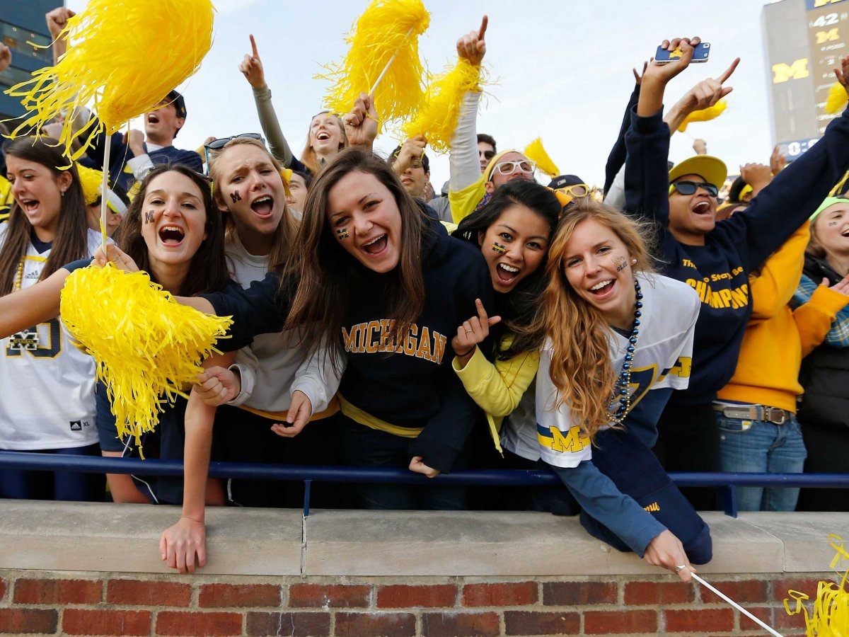 Fans cheer at a Michigan football game.