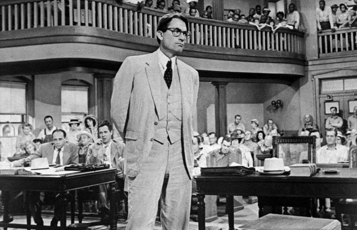 Atticus Finch stands in a court room in black-and-white