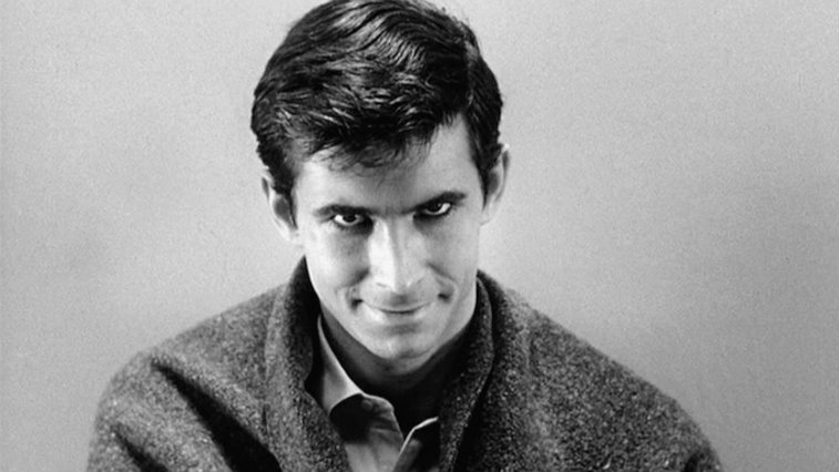 Anthony Perkins as Norman Bates is smirking at the camera.