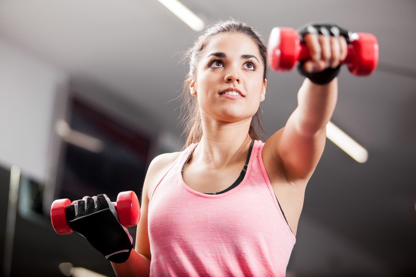 woman working out with some dumbbells