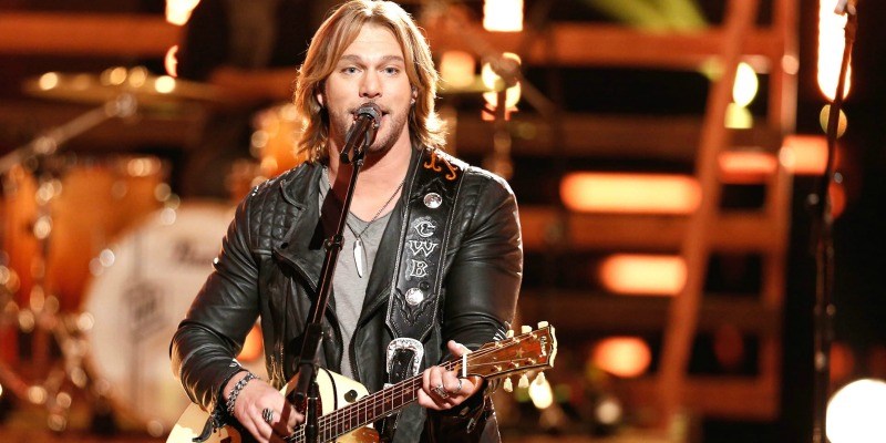 Craig Wayne Boyd performs on stage with his guitar on The Voice.