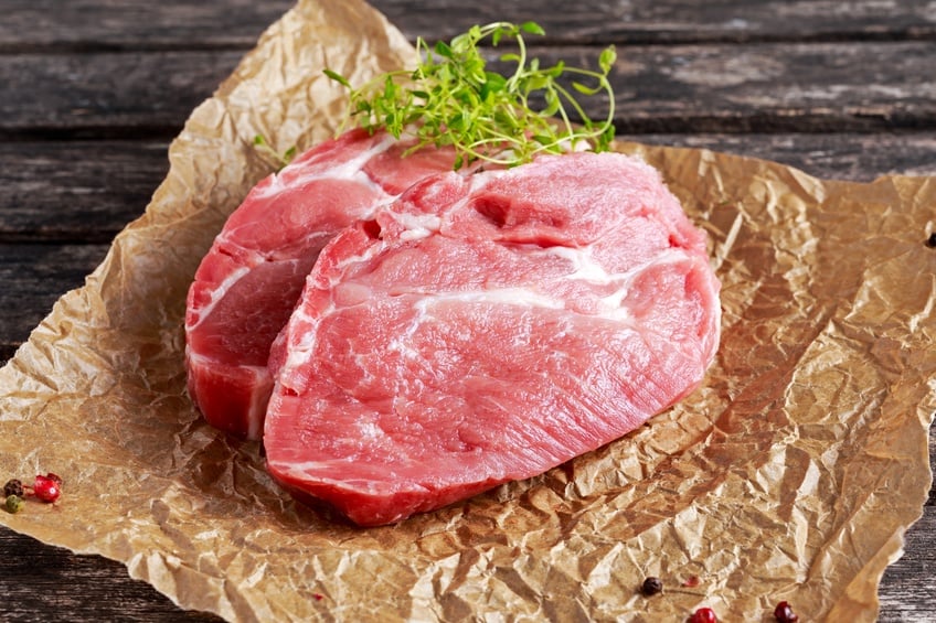 Raw pork shoulder on butcher paper 