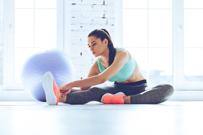 woman in sportswear doing stretching woman in sportswear doing stretching