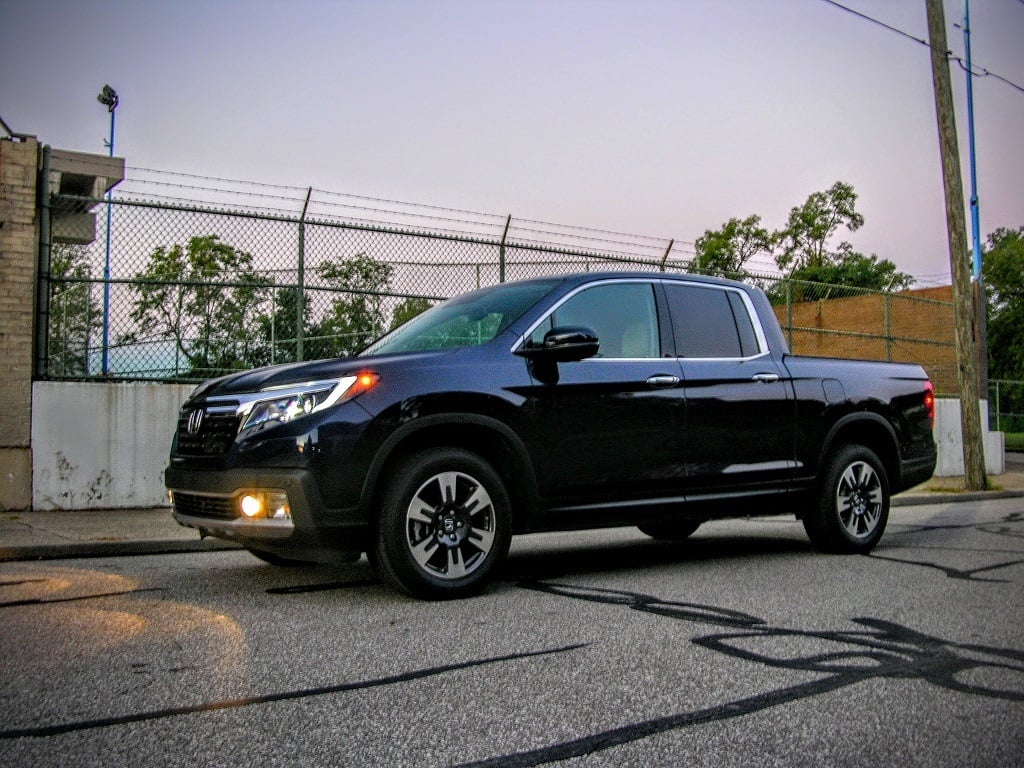 Black Honda Ridgeline parked on a street.