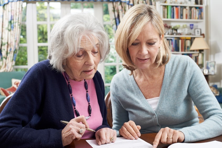 woman helping senior woman