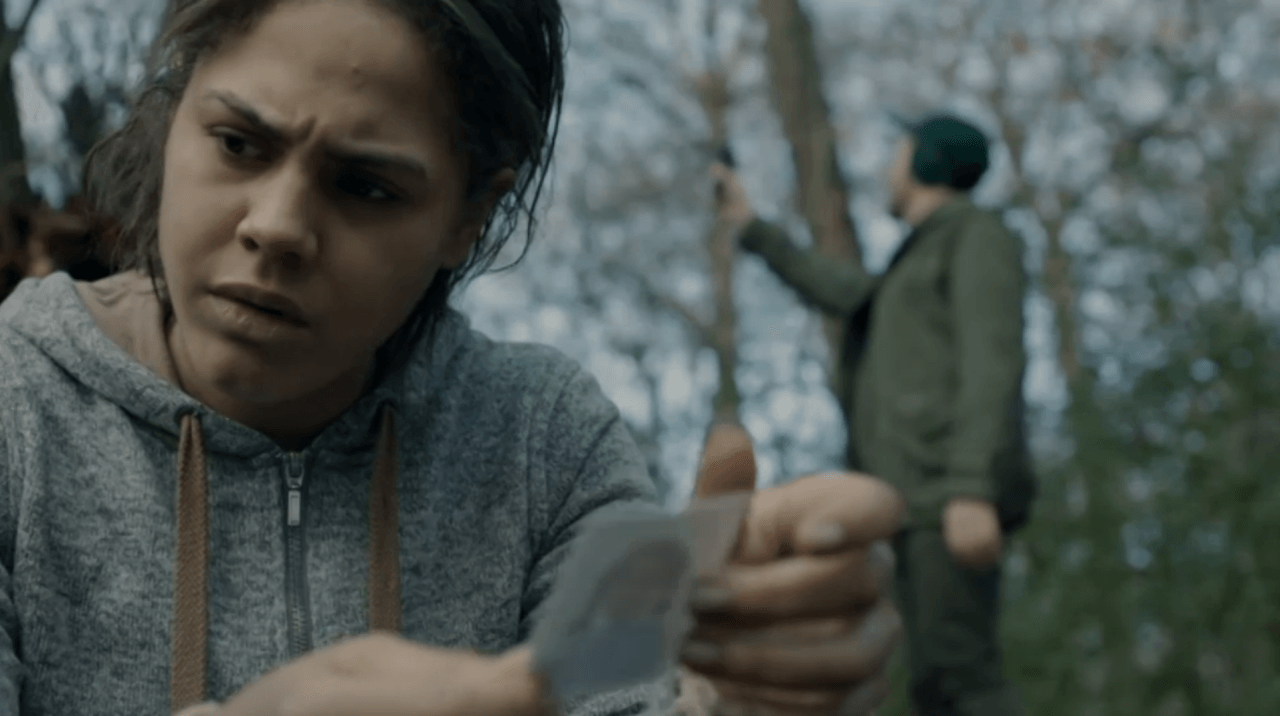 Victoria (Lenora Critchlow) examines a photo in a scene from 'Black Mirror's "White Bear"