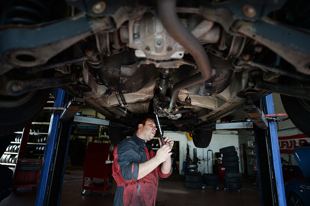 An employee of an automobile garage at work