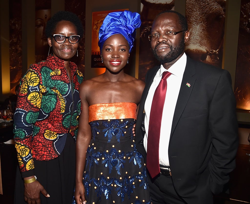 Lupita Nyong'o attending a movie premiere standing next to her parents