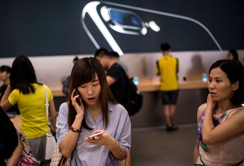 A Chinese woman tests the new iPhone 7 during the opening sale launch at an Apple store