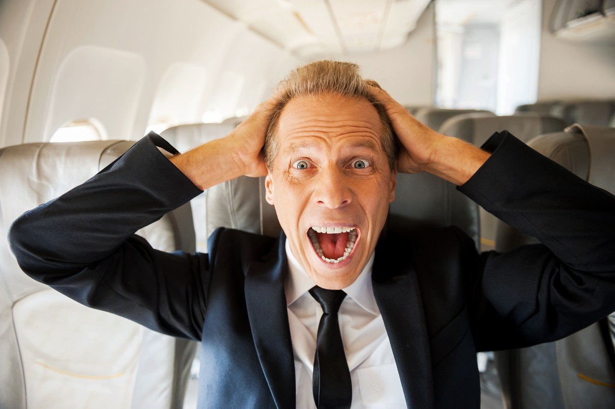 businessman shocked in airplane