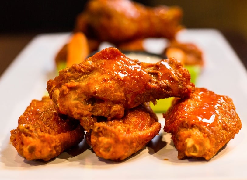 delicious hot wings dripping in sauce