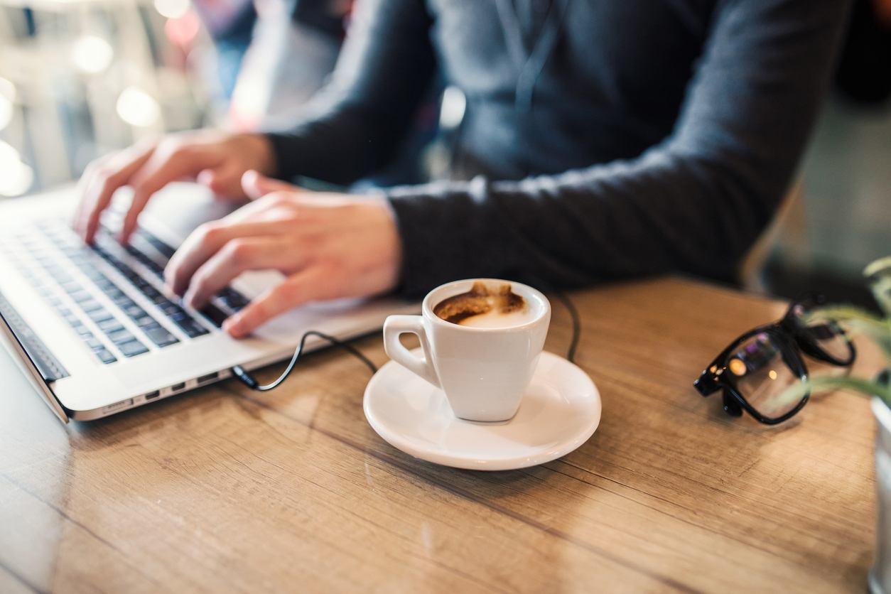 Man working on his laptop in cafe