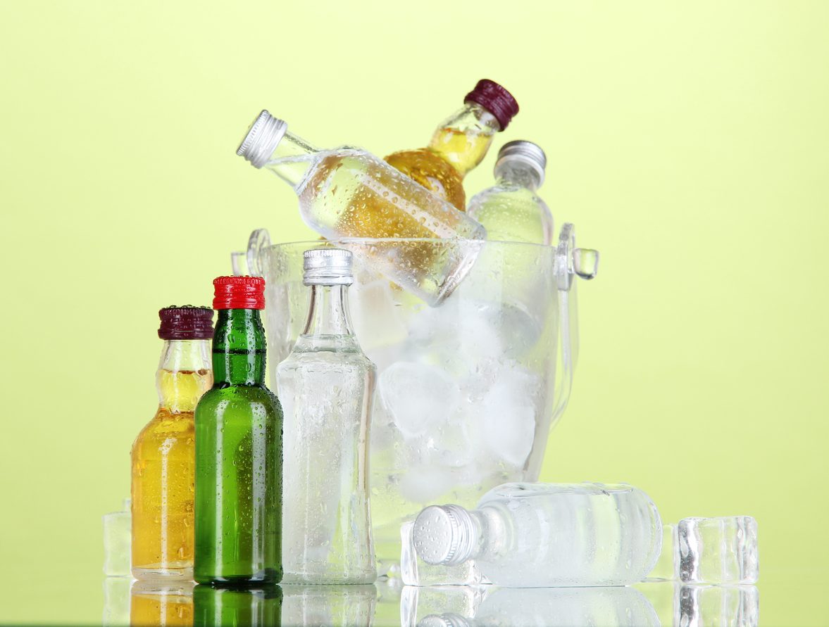Minibar bottles in bucket with ice cubes