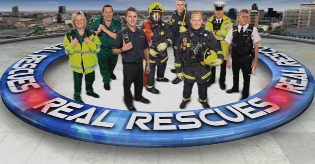 Eight emergency responders stand in front of a city backdrop in poster for Real Rescues 