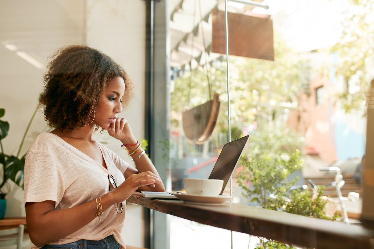 woman at cafe using laptop