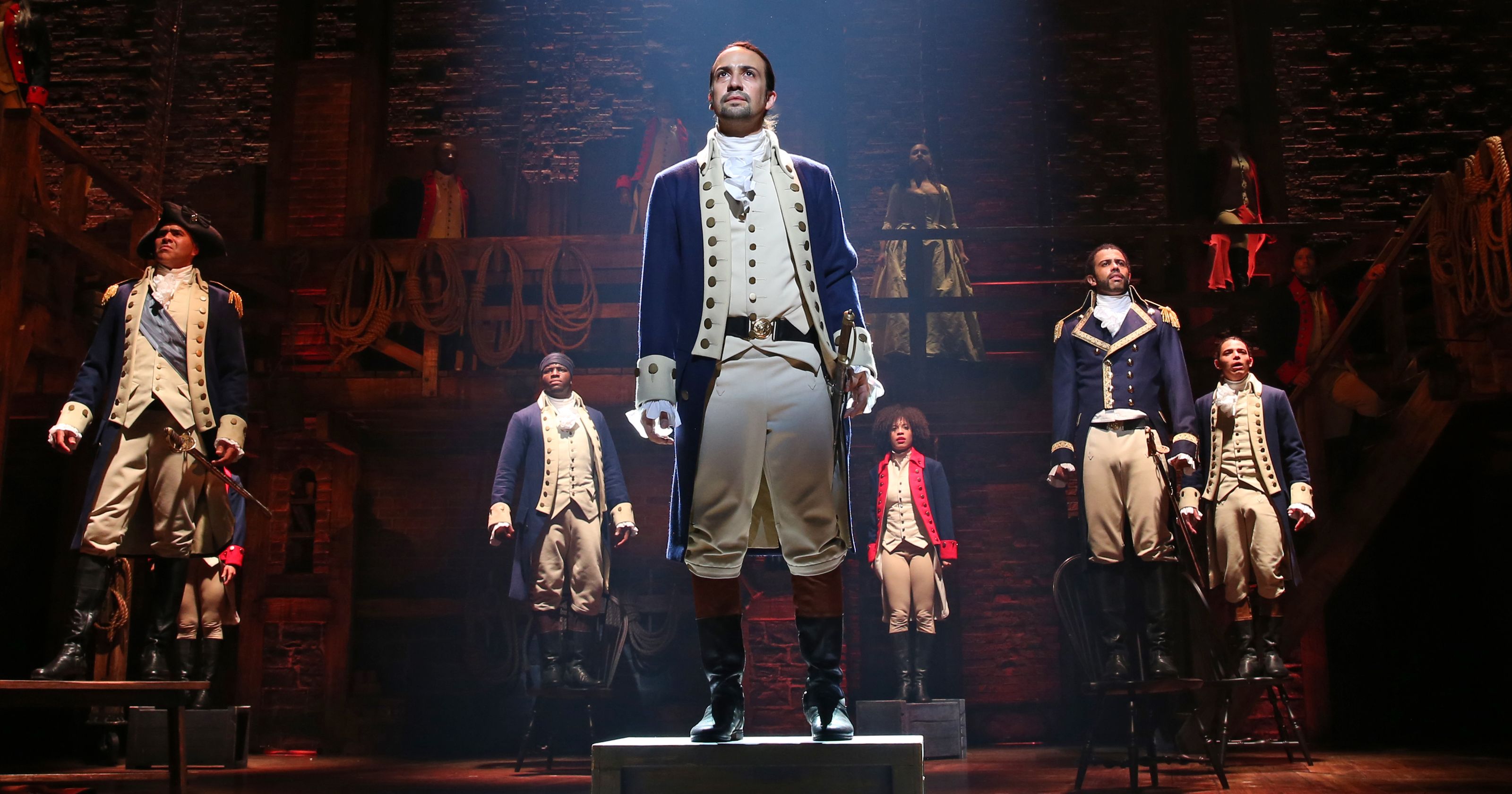 'Hamilton's ensemble stands on chairs during "The Battle of Yorktown."