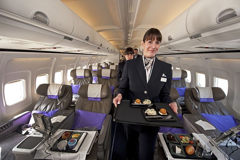 flight attendant serving a meal 