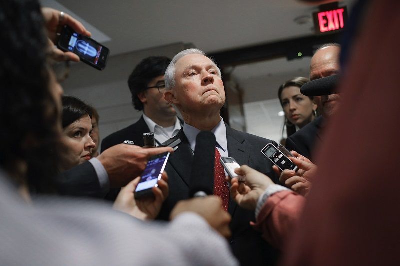 Sen. Jeff Sessions talks with reporters after a briefing