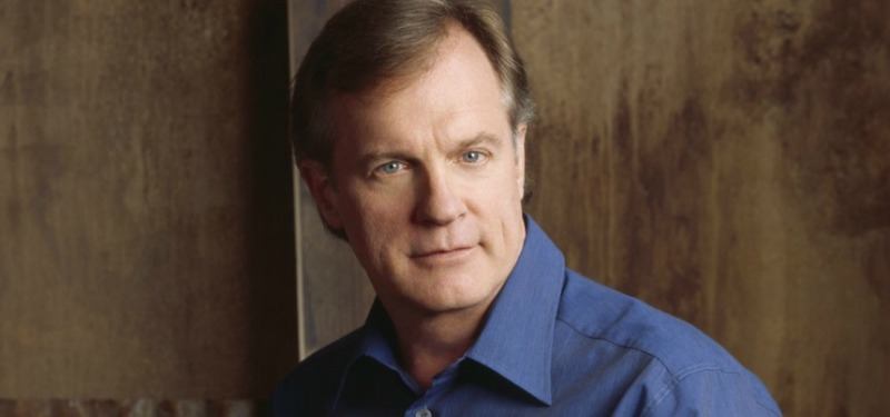 Stephen Collins is in a blue shirt and looking at the camera.