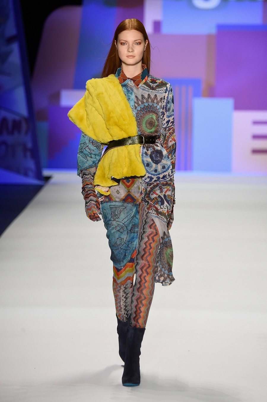 A model walks the runway wearing Desigual Fall 2016