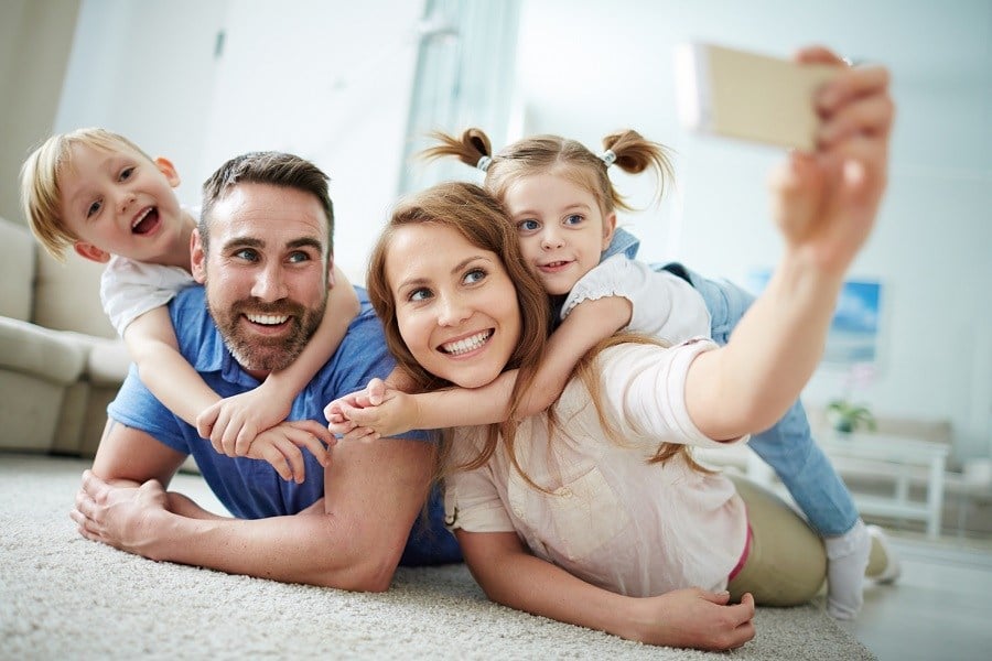 young family taking selfie on the floor