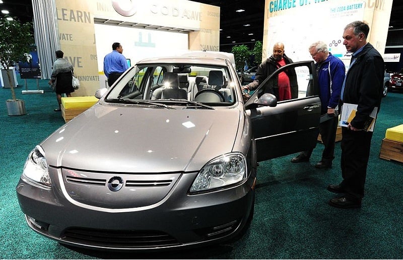 Potential car buyers view the CODA electric car February 2, 2012 at the 2012 Washington Auto Show at the Walter E. Washington Convention Center in Washington, DC. The CODA sedan, is a four-door, five passenger electric car powered by a battery pack that is expected to deliver a range of 150 miles (240 km) per charge according to CODA. The auto show runs through February 5.