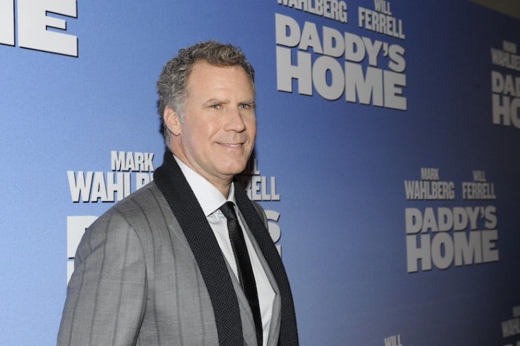 Will Ferrell smiling on the red carpet in a grey suit