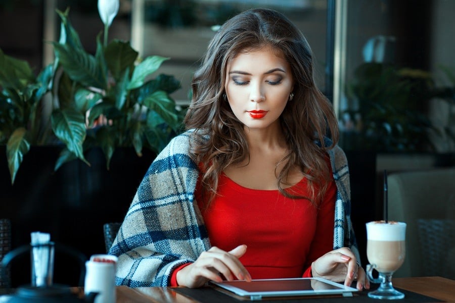 Girl wrapped in a blanket sitting and working