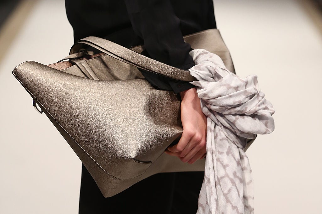 A bag is pictured as a model walks the runway