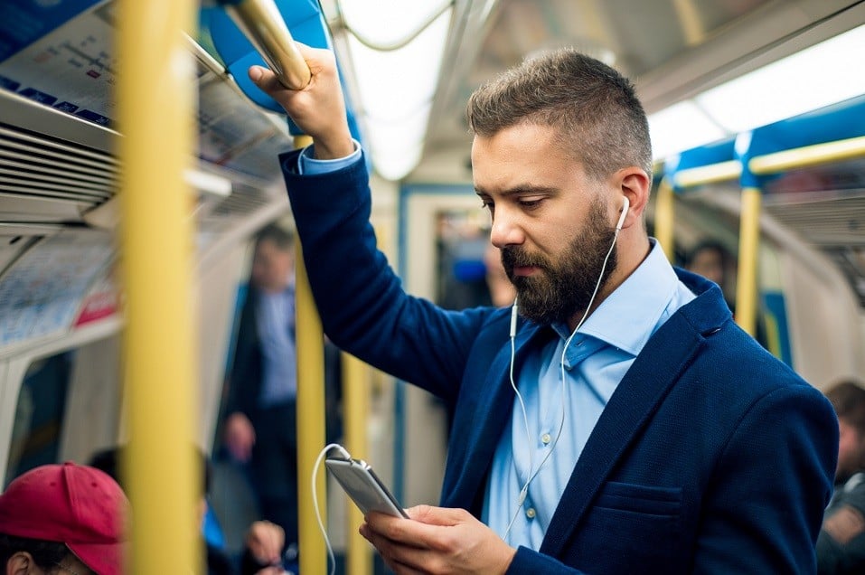 businessman with headphones travelling to work