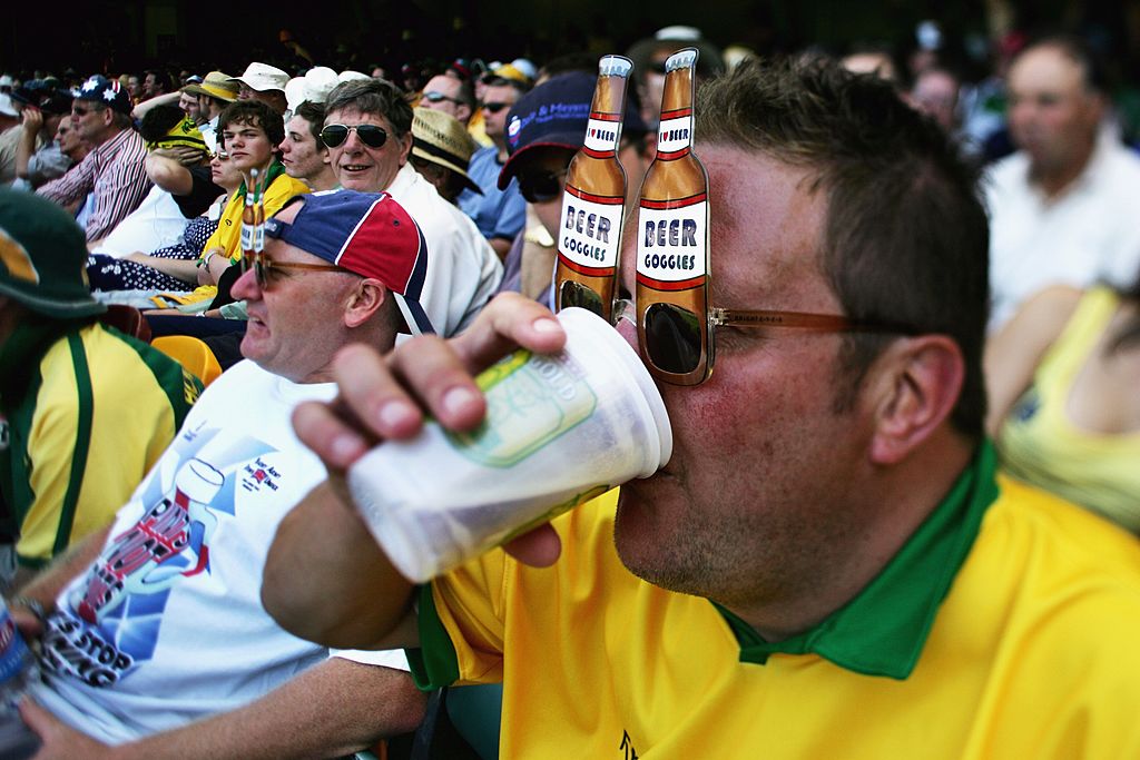 A member of the Fanatics drinks beer at the Gabba cricket ground