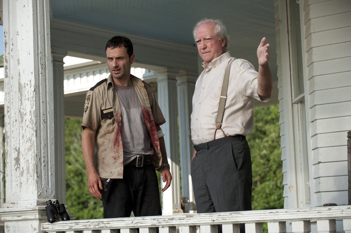 Rick (Andrew Lincoln) and Hershel (Scott Wilson) stand on the farmhouse porch in a scene from Season 2 of 'The Walking Dead'