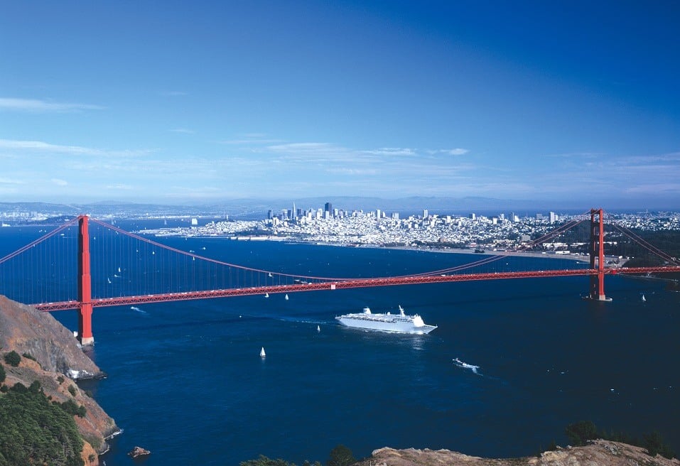 A cruise ship makes its way under the Golden Gate Bridge in San Francisco, California