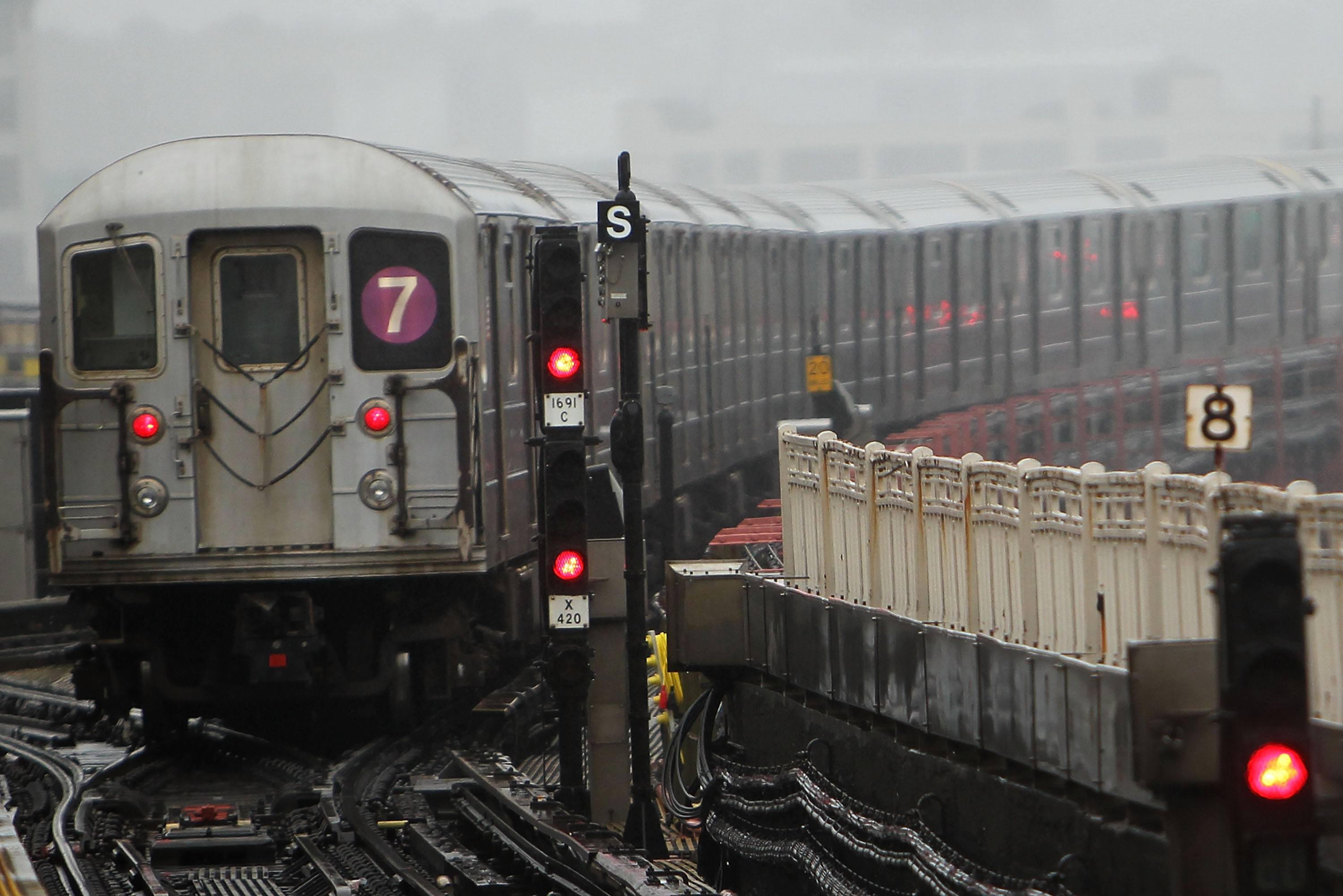 A New York City Subway train pulls away from a station