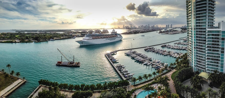 A panorama shot showing a cruise ship making its way down Miami Beach, Florida