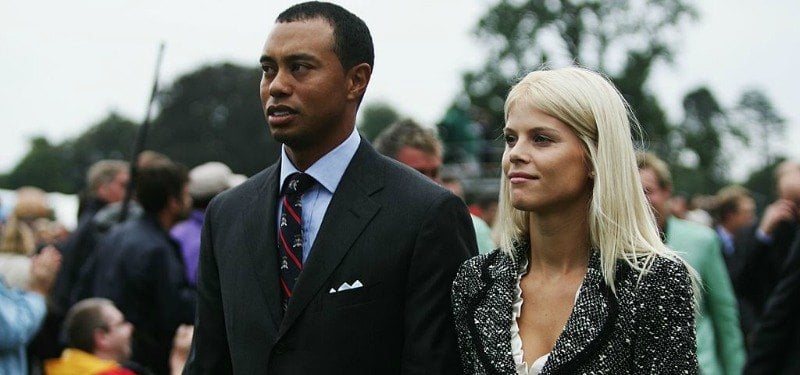 Tiger and Elin Woods are standing next to each other.