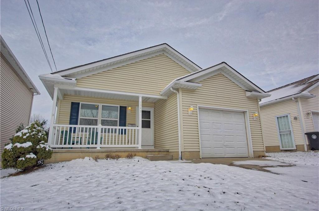 Home with a snowy front yard