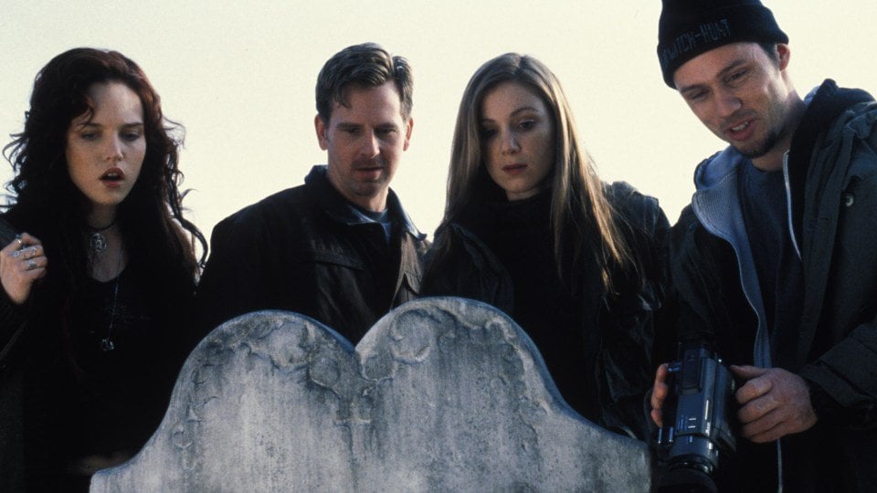 The cast of Book of Shadows all stand over a headstone