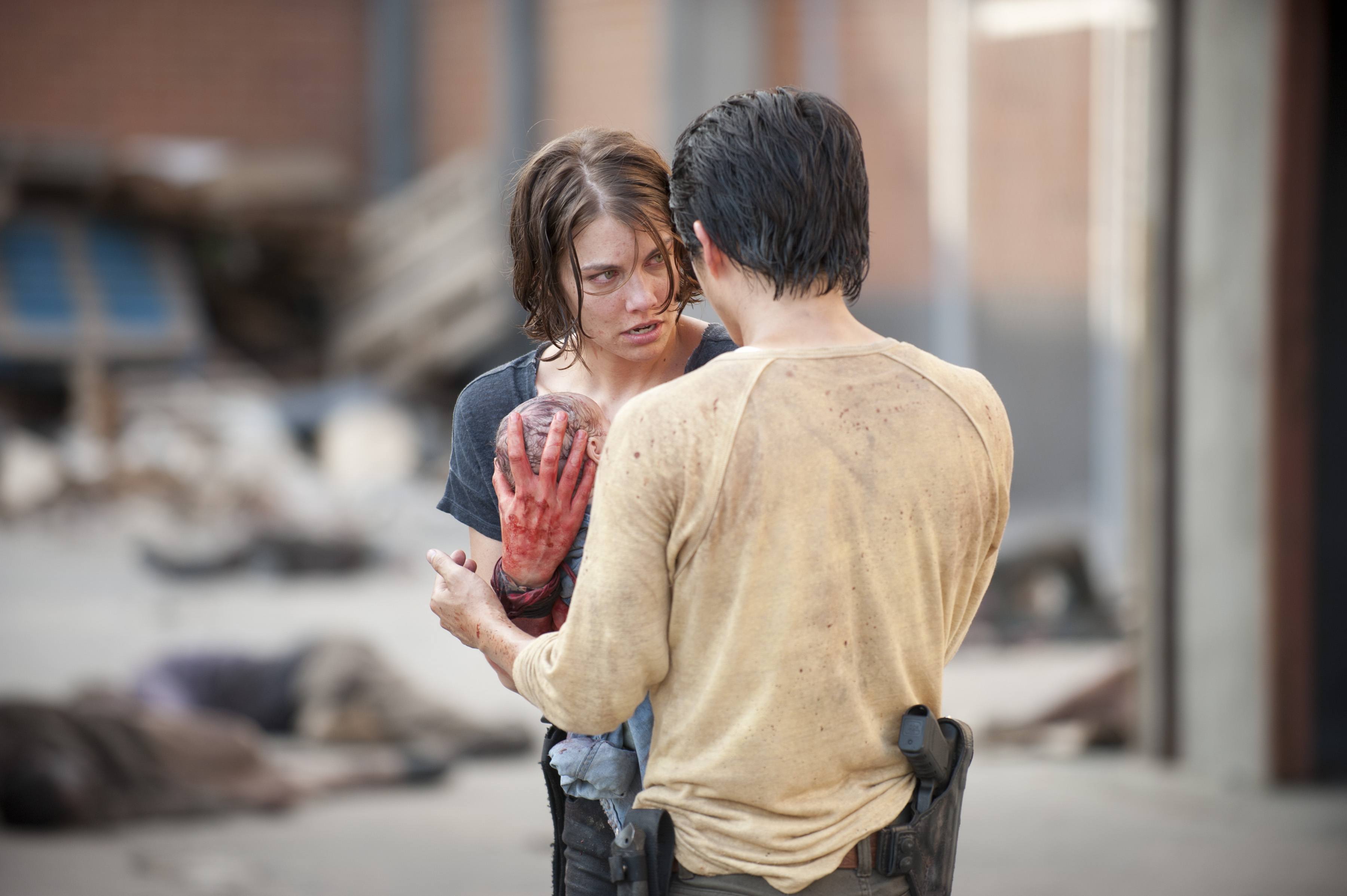 Maggie carries a newborn Judith to Glenn in a scene from 'The Walking Dead' episode "The Killer Within"