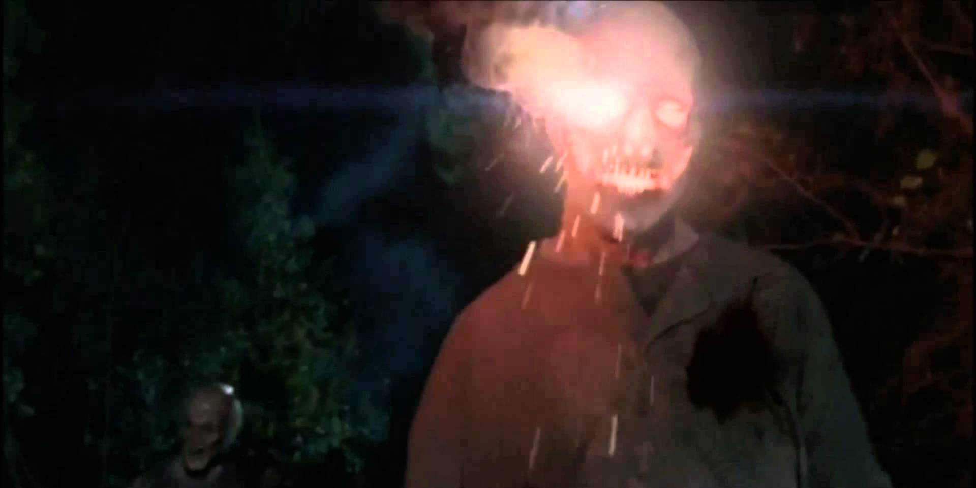 A walker's head is lit with a flare in a scene from the Season 5 episode of 'The Walking Dead,' "The Distance"