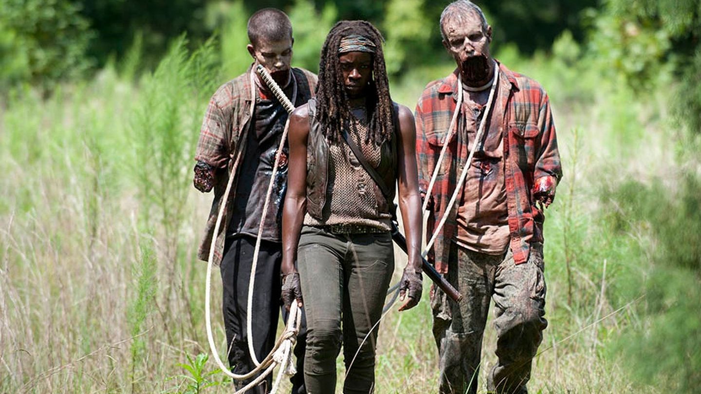 Michonne (Danai Gurira) walks with her two walkers on leashes in a scene from 'The Walking Dead'