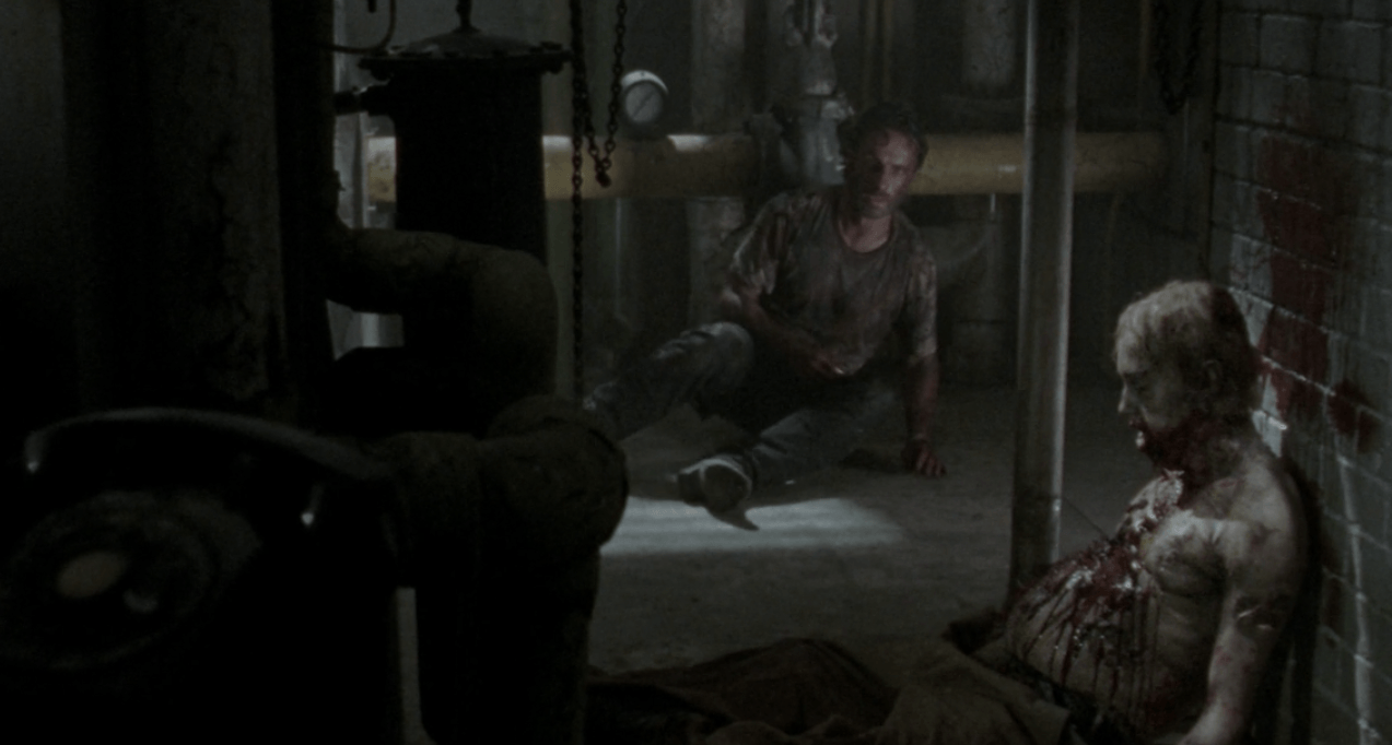 Rick sits near the zombie that ate Lori in a scene from the Season 3 'Walking Dead' episode "Say The Word"