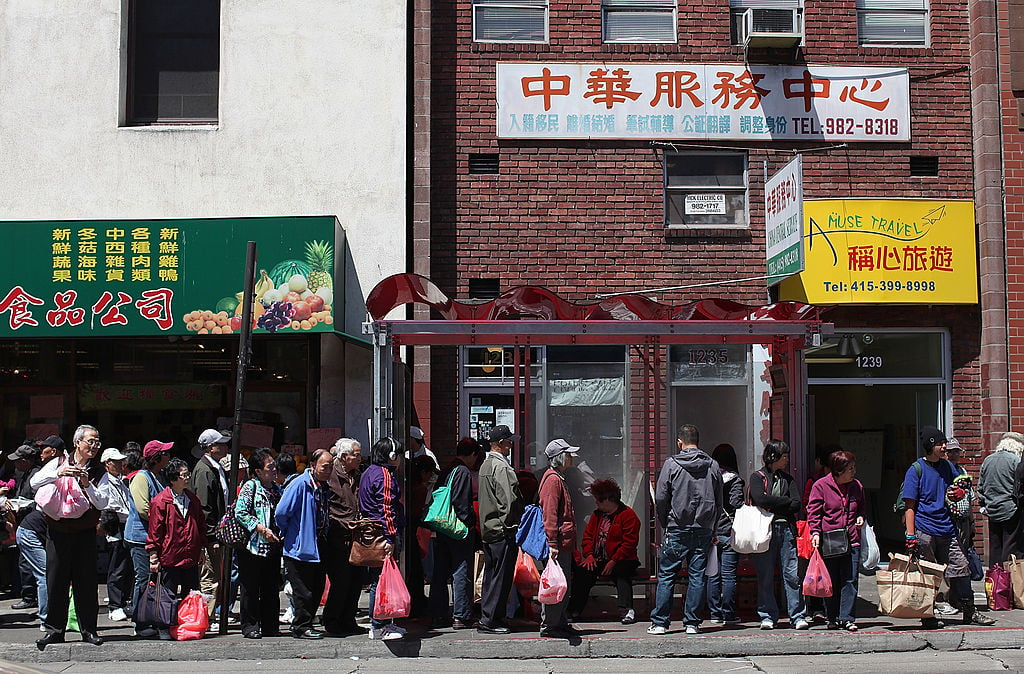 People wait for a bus in Chinatown