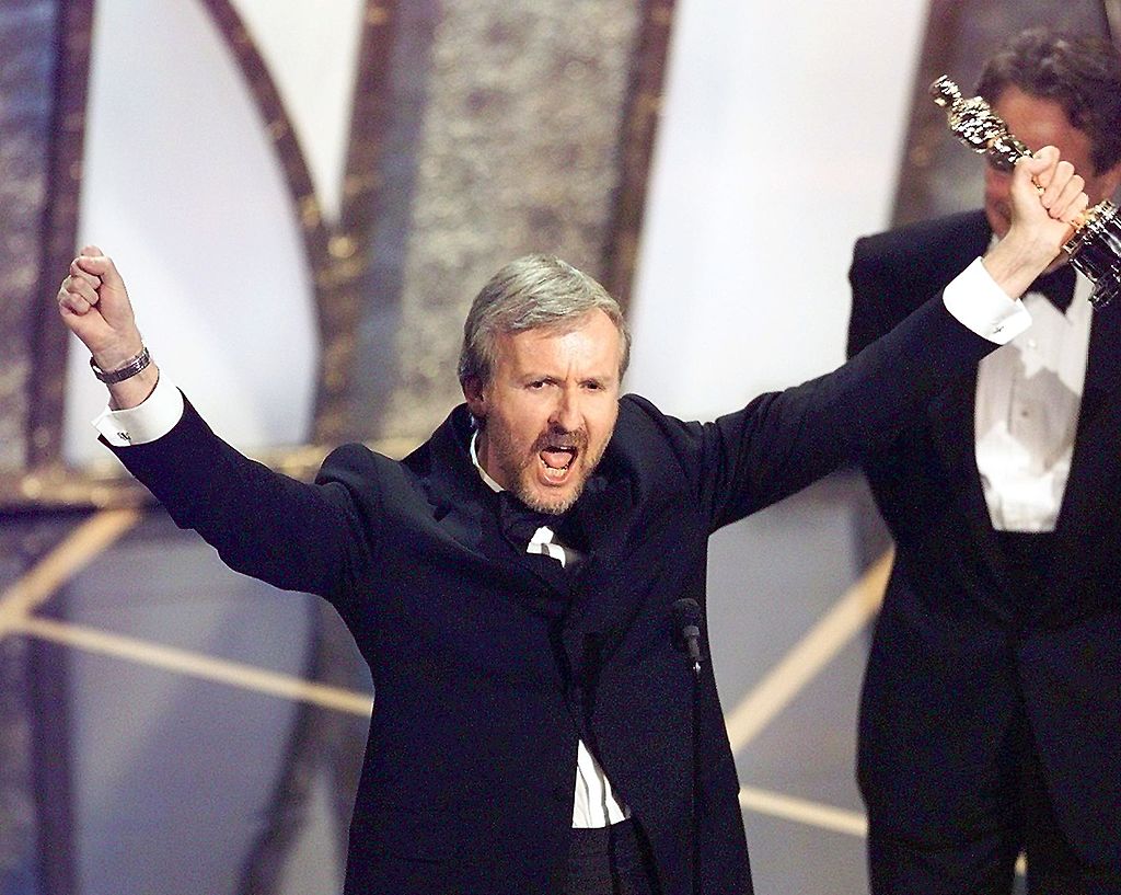 Director James Cameron raises his Oscar after winning in the Best Director Category during the 70th Academy Awards