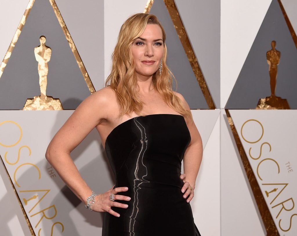 Actress Kate Winslet stands with her hands on her hips at the 88th Annual Oscars