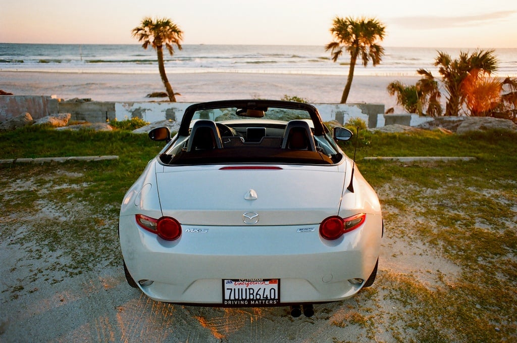 rear view of the 2017 Mazda Miata GT parked on a beach