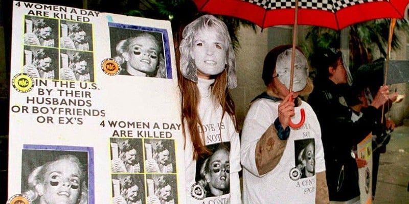 Members of the Women's Action Coalition wearing Nicole Brown Simpson masks protest